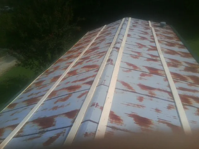 Rusted metal roof panels with new wood purlins before replacement — Storm Damage Roof Repair in Bardstown by Roofing Brothers