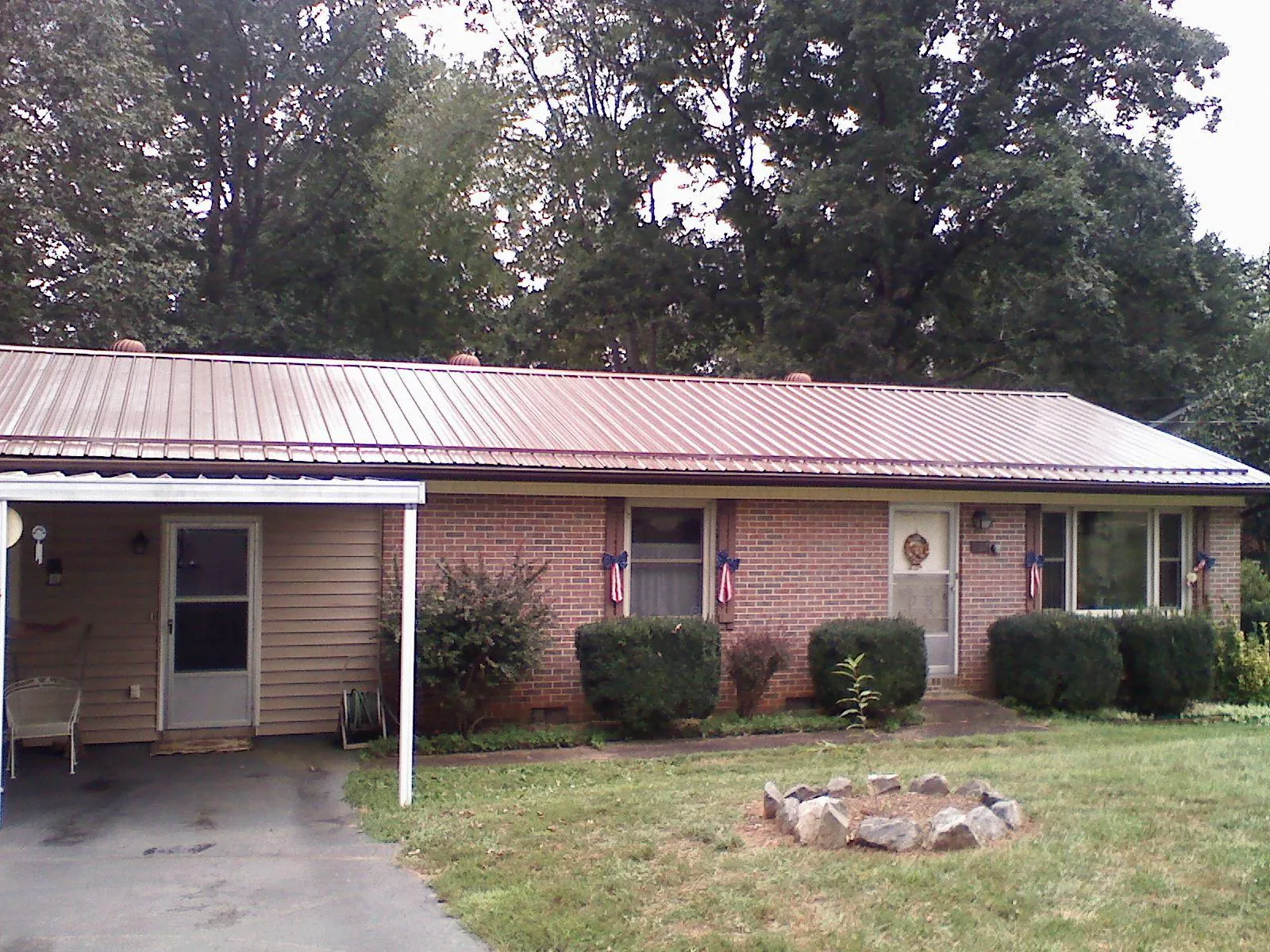 Bronze metal roof and carport on a brick ranch home — Roof Repair work by our crew in Bardstown
