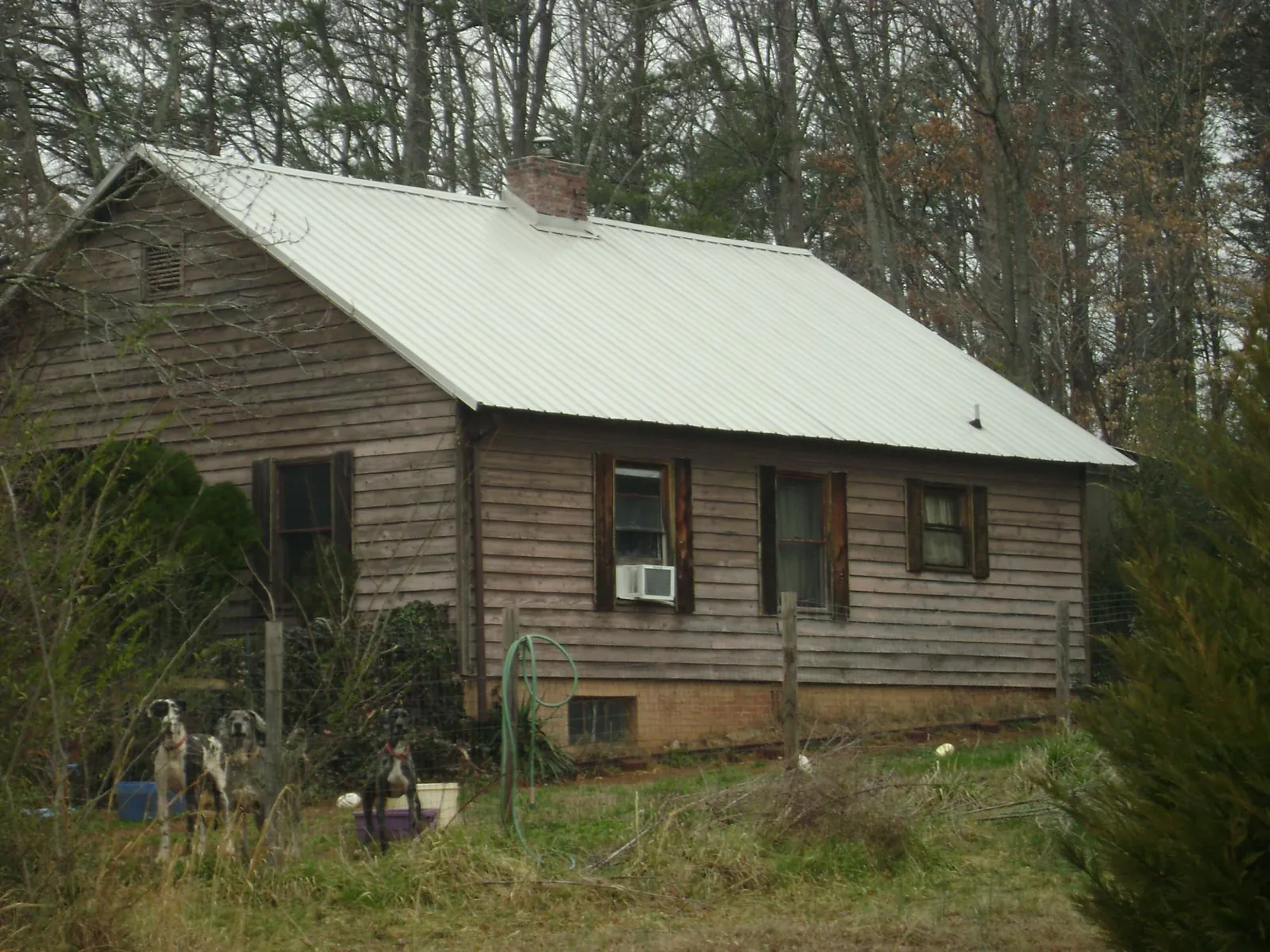 White metal roof on an old wood sided farmhouse, from a Metal Roof Installation job in Bardstown